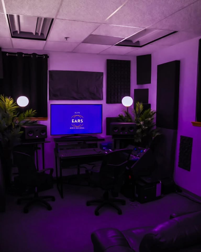 EARS Studio, a purple-lit production room with studio monitors, two workstations and acoustic panels