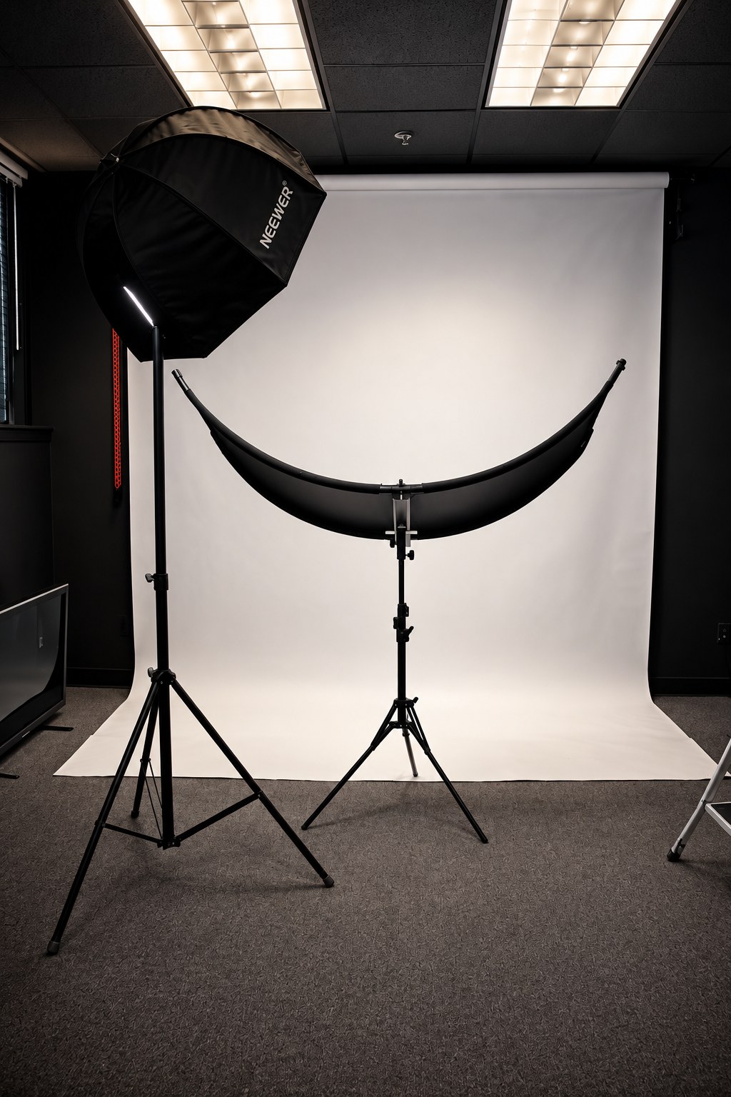 The Multimedia Room set up for a photo shoot with a white backdrop, softbox and reflector